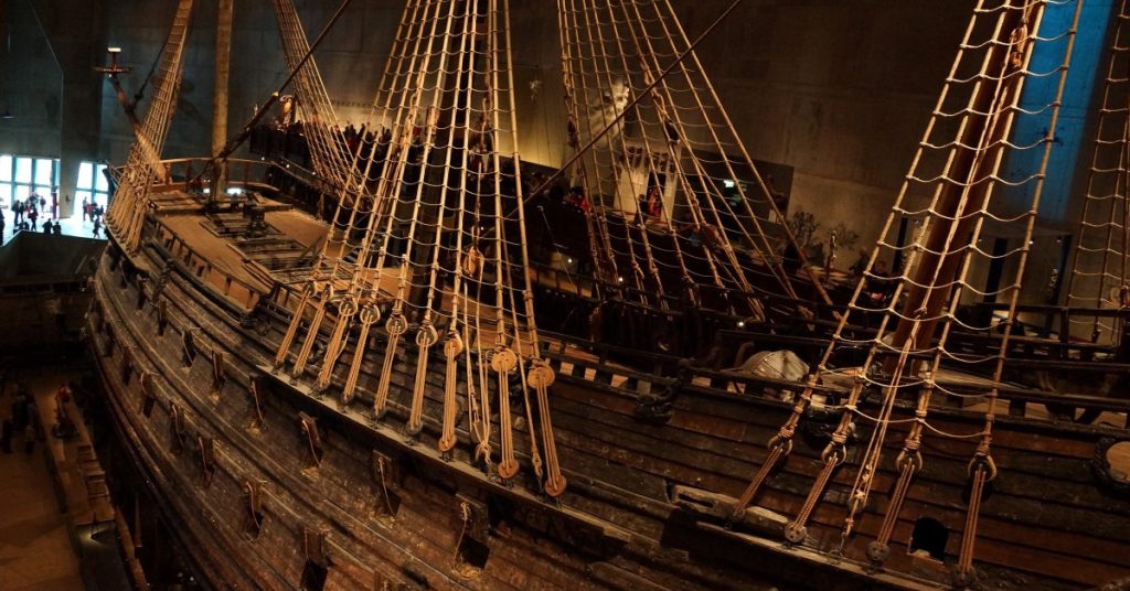 Wooden historic sailing ship displayed in museum for maritime history exploration.