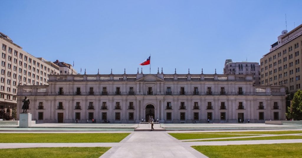 Historic government building in Santiago, Chile, under clear blue sky.