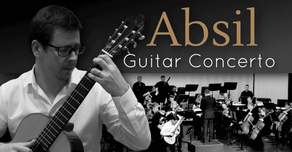 Acoustic guitarist performing at Abil Guitar Concerto event in a concert hall.